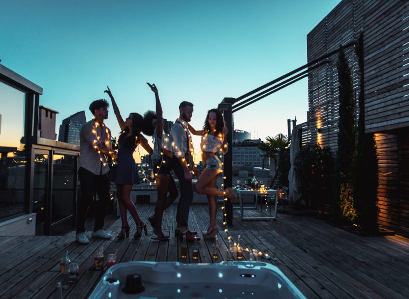 Multi-ethnic group of friends having party on  rooftop - Happy people bonding and having fun