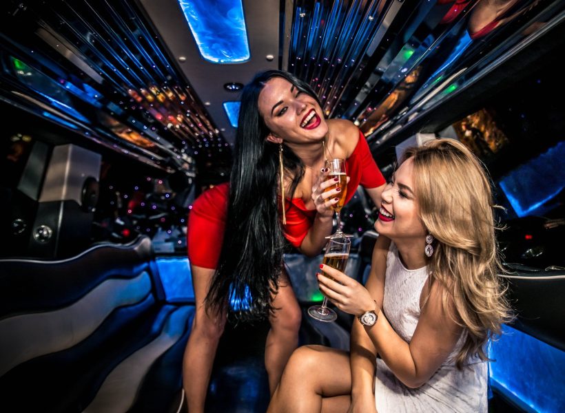 Pretty women having party in a limousine car