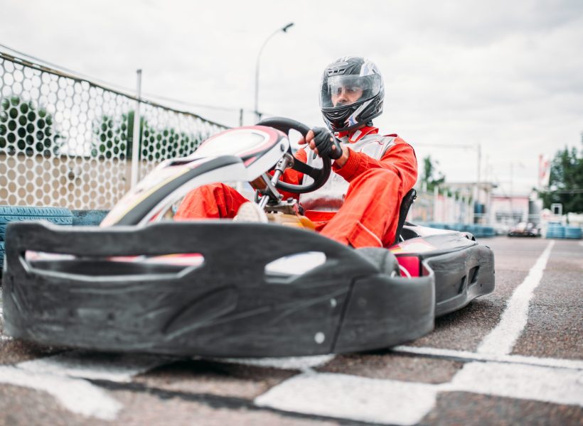 Kart racer on start line, go cart driver. Carting speed track, motor sport