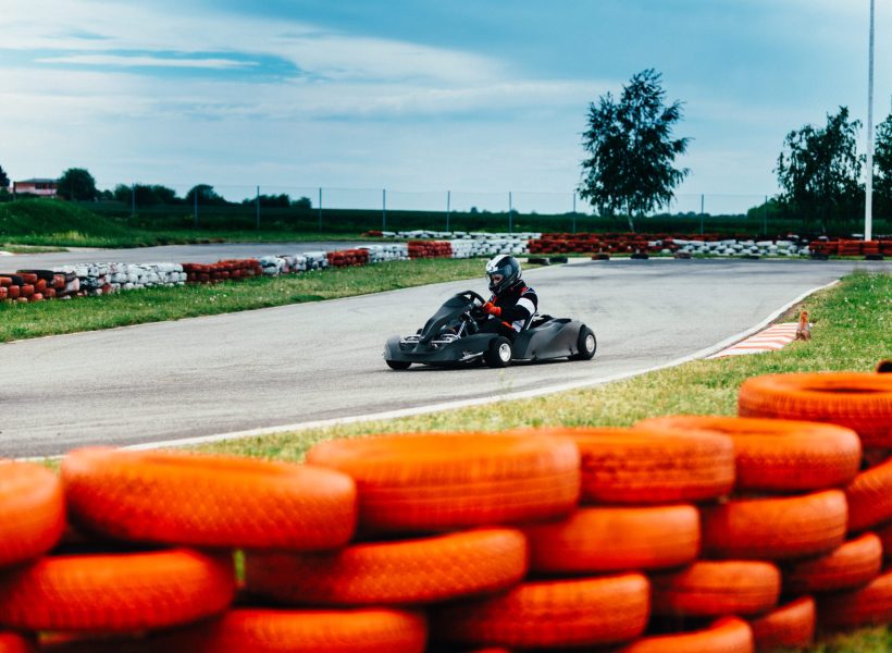 Woman driving go-cart on a sports track